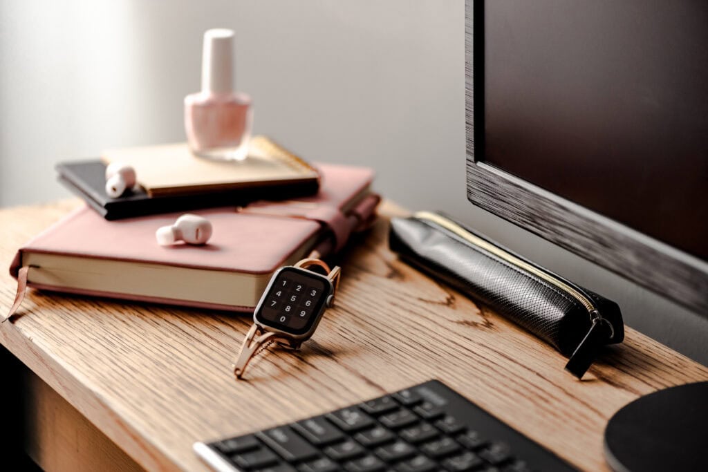 picture of work desk with watch as focus for an article about how to make more money and work less